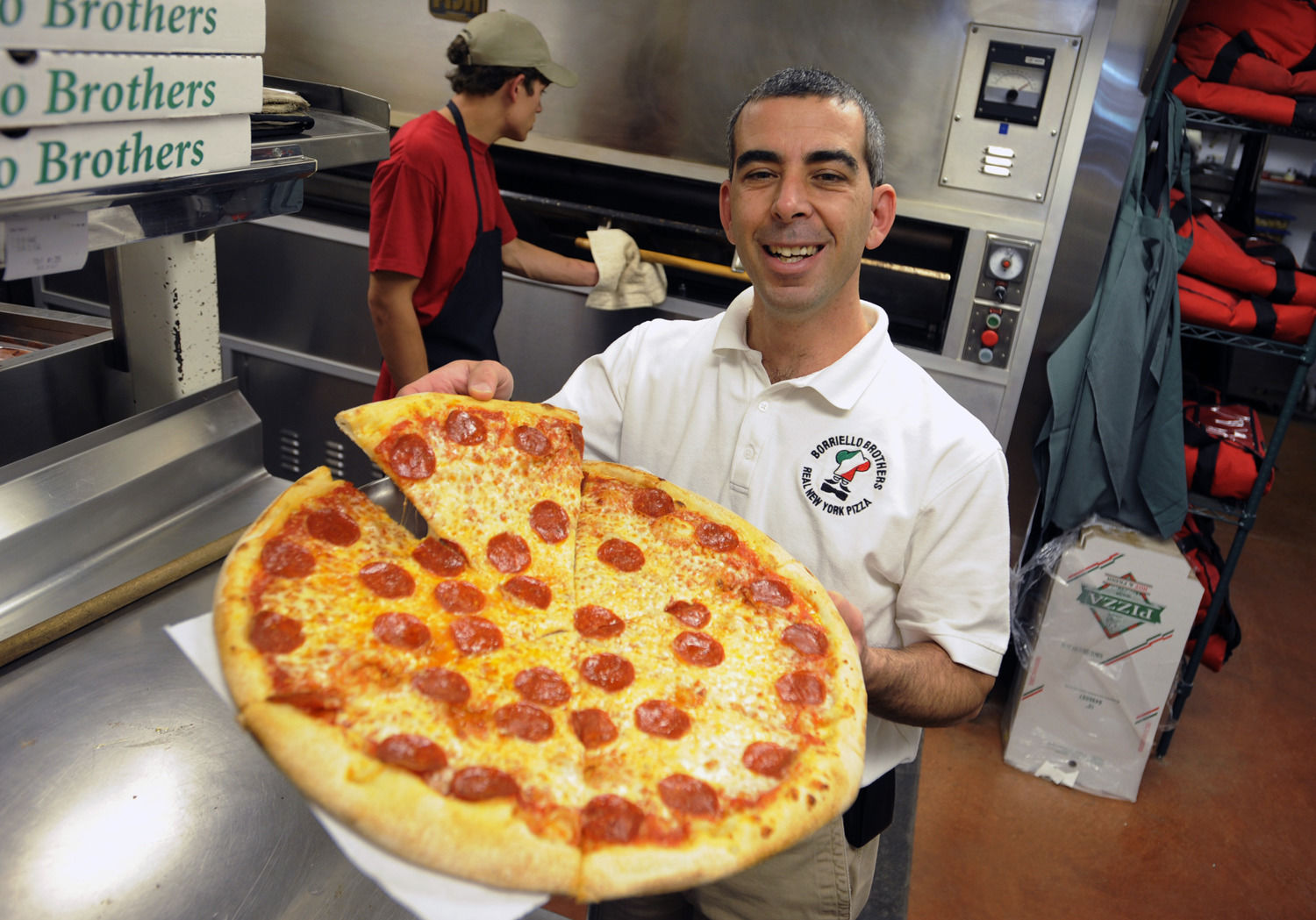 Borriello Brothers owner Rob Raia, held a piece of his pepperoni pizza at his 8th Street location 10/23/09. They specialize in New York Style pizza and have been in town since 1999. CAROL LAWRENCE,THE GAZETTE
